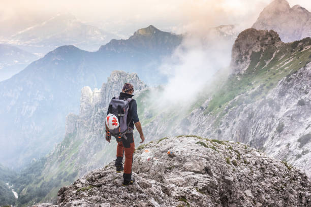 istock Alpinist on mountain peak 1165125506