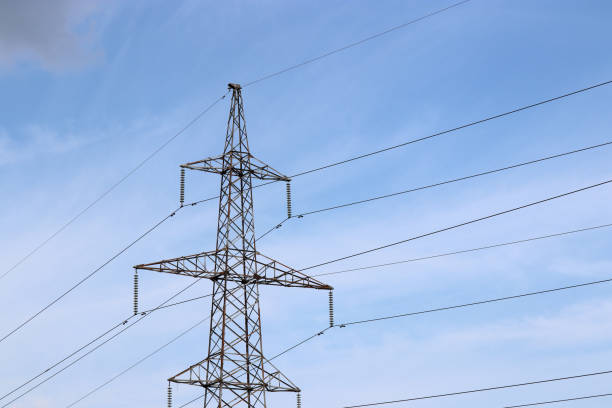 istock High voltage power line support with electrical wires on cloudy sky 1165125622