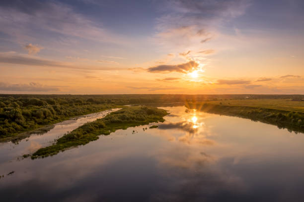 istock Aerial view to sunset on the river at summer evening with cloudy sky. 1165126229