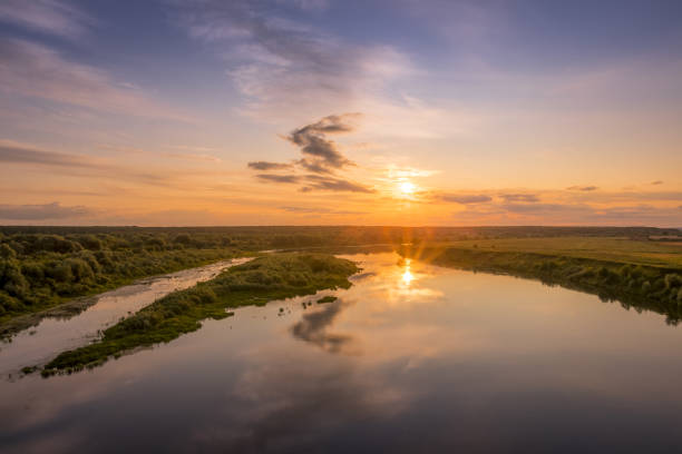 istock Aerial view to sunset on the river at summer evening with cloudy sky. 1165126245