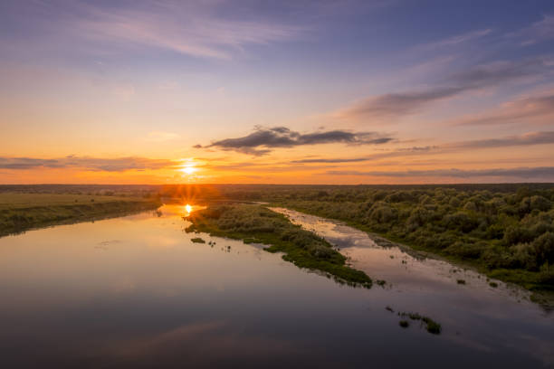 istock Aerial view to sunset on the river at summer evening with cloudy sky. 1165126251