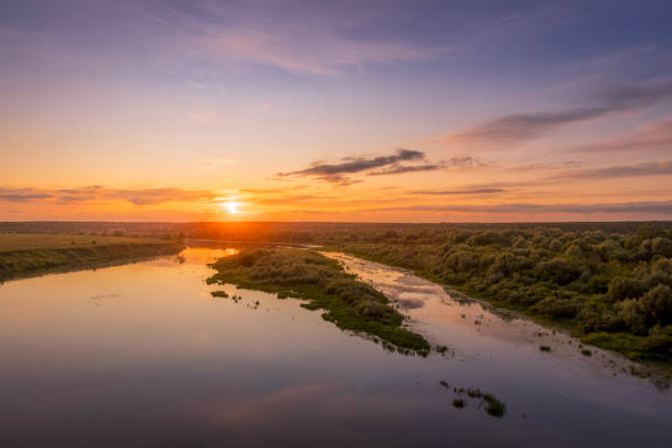 istock Aerial view to sunset on the river at summer evening with cloudy sky. 1165126867