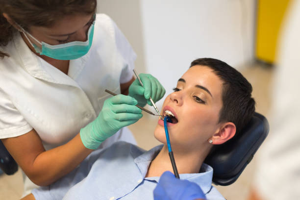 istock Young woman at the dentist 1165127610