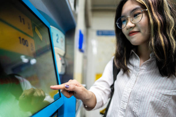 istock Asian girl buying subway train tickets 1165129770