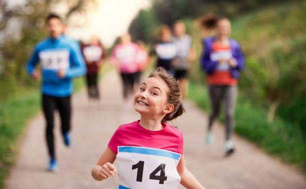istock Large group of multi generation people running a race competition in nature. 1165132040