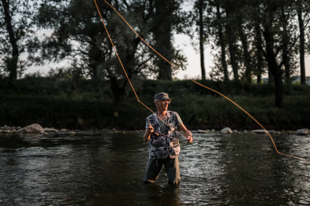 istock Man enjoys while fly fishing 1165132252