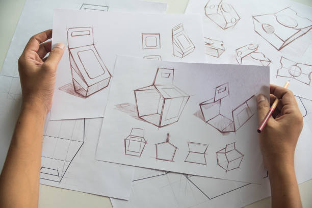 istock Designer sketching drawing design Brown craft cardboard paper product eco packaging mockup box development template package branding Label . designer studio concept . 1165132929