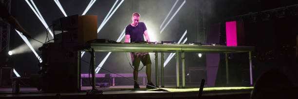 istock Dj playing techno music on the stage 1165132975