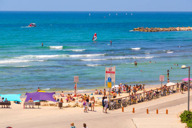 Tel Aviv, Israel - June 9, 2018: Beach promenade of Tel Aviv. Locals and visitors enjoy the blue-flagged sandy beaches of the Mediterranean Coast in Tel Aviv.