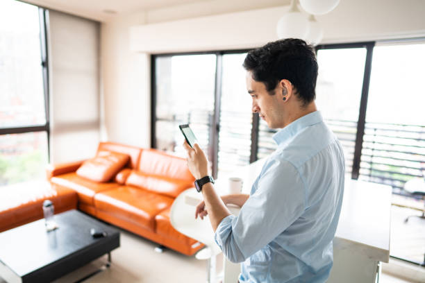 istock Hearing impaired man using smart phone in the kitchen 1165133217