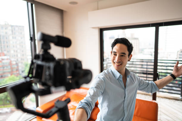 istock Mixed race man recording vlog in apartment 1165133270