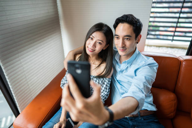 istock Loving couple making selfie at home 1165133304