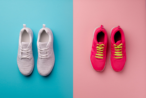 A studio shot of running shoes on bright color background. Flat lay, top view.