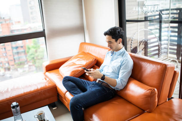 istock Hearing impaired man text messaging at home 1165133675