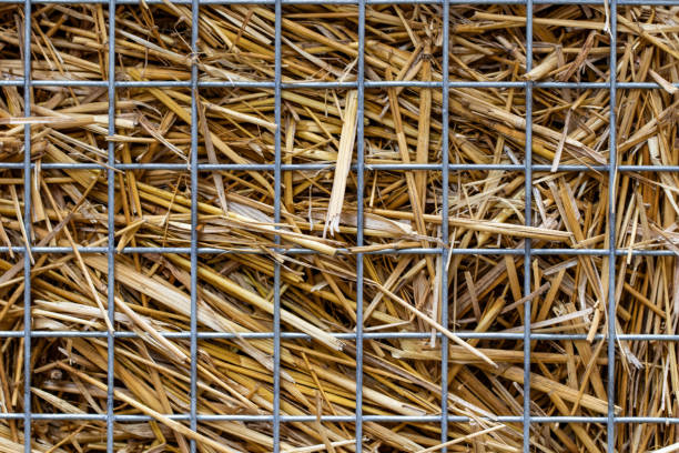 abstract background with straw behind the net fence close-up.