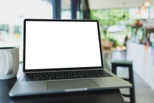 istock Laptop mockup and hot espresso in a white coffee mug On the table 1165138676