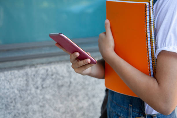 istock Student girl using smartphone at the college 1165138702