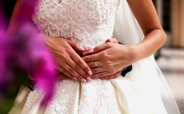 istock Bride and groom holding hands close up in the wedding day 1165140972