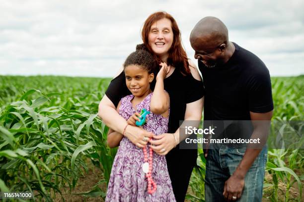 Portrait Of Mixedrace Family With Autist Daughter In Nature Stock Photo - Download Image Now