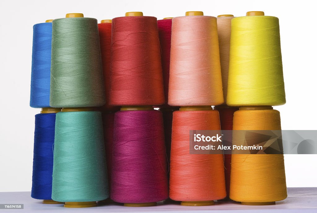 A pile of multicolored spools of sewing thread spools of sewing threads Thread - Sewing Item Stock Photo