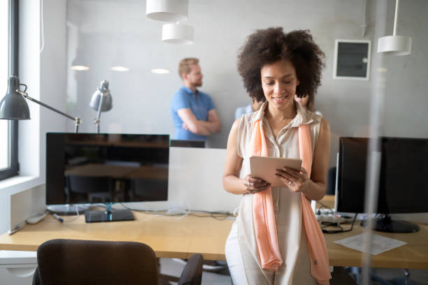 istock Young african american woman working with tablet in office 1165141599