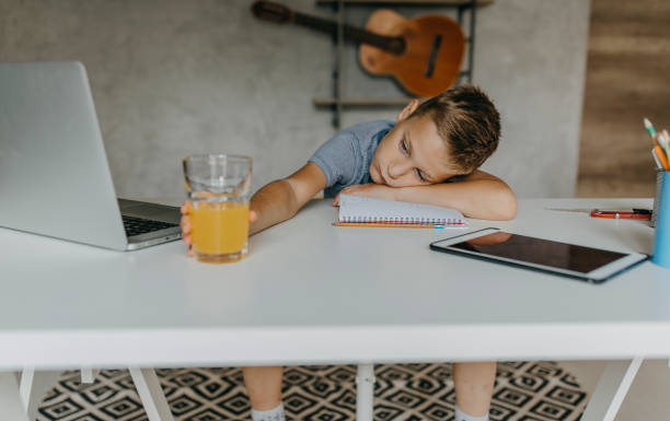 istock Boy tired of doing homework 1165141820