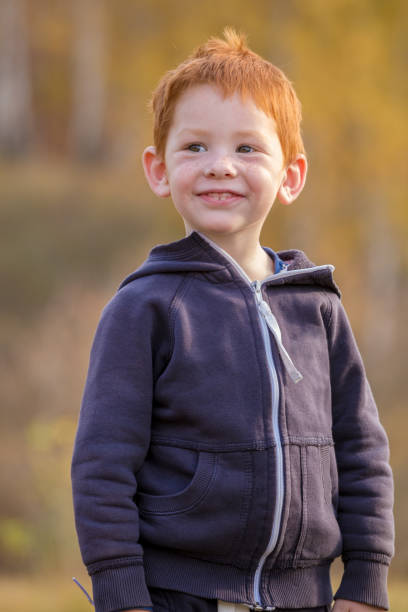 istock Adorable little boy standing on autumn landscape 1165143067