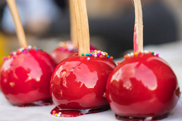 Sweet glazed red candy apples on sticks.