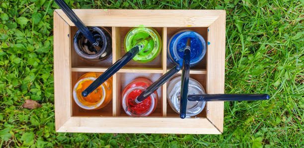 Water colors in jars on the grass