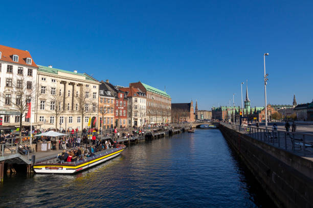 Copenhagen, Denmark - April 18, 2019: Sightseeing tour by boat in a touristic canal. Discovering Copenhagen from the water with canal tour boat