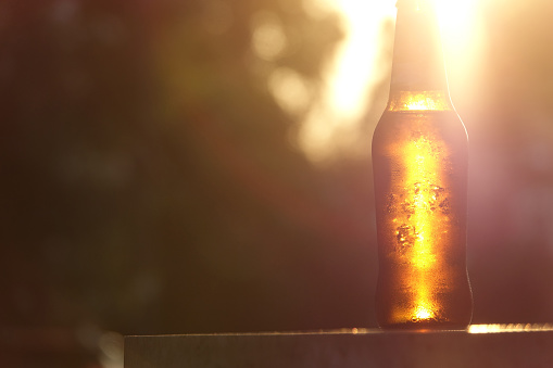 Bottle of beer at sunset