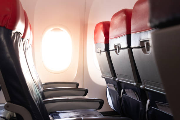 istock Empty airplane seats and window.Passenger seats in economy class.airplane interior 1165145515