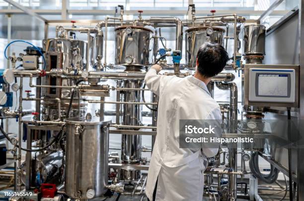 Back View Of Male Student Working At The Process Lab Distilling Liquids Stock Photo - Download Image Now