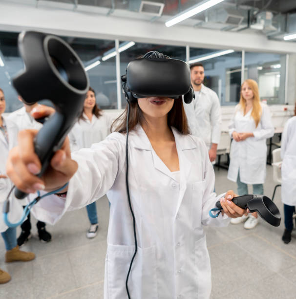 learning during a design class using a vr headset and joysticks - smiling research science and technology clothing imagens e fotografias de stock