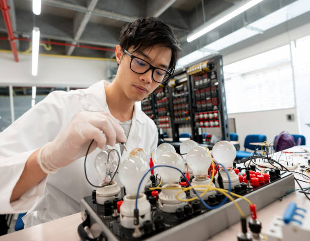 Asian Student At Electronics Laboratory Experimenting Stock Photo - Download Image Now - iStock