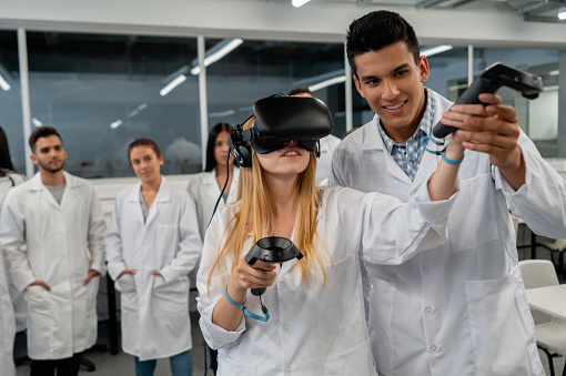 Lab Partner Friends Handsome Lab Partner Helping Friend While She Is Wearing A Vr Headset ...