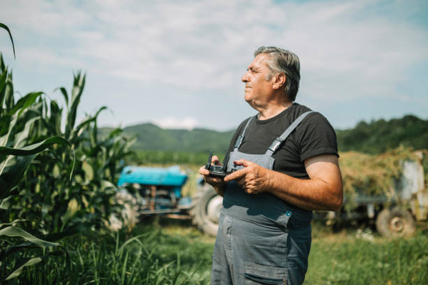 istock Mature farmer flying a drone over a field 1165146682