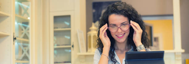 istock Woman selecting eyeglasses in optical store 1165147734