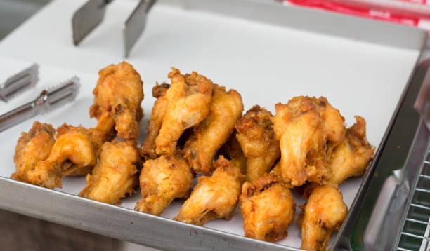 istock Fried chicken wings meat in market. 1165148658