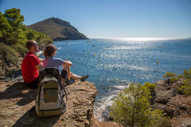 istock Walkers take a rest and look out over the beautiful view from coastal path 1165148691