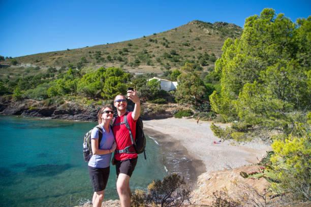 istock Tourist hikers taking a selfie with mobile phone on coastal path 1165148692