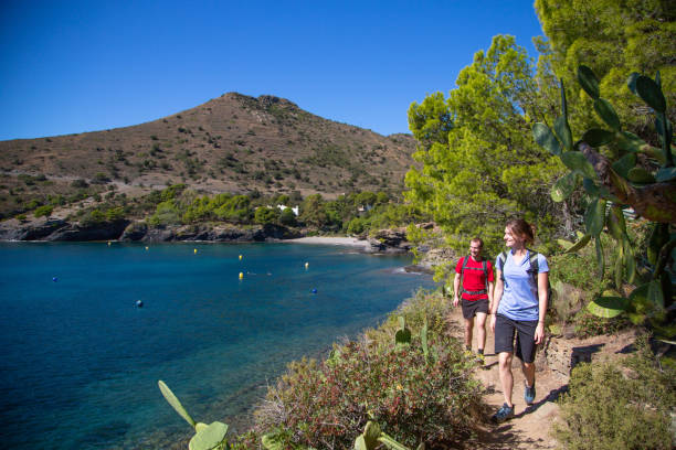 istock Couple walking along Mediterranean coastal path, Catalonia 1165148697