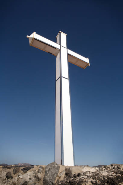 istock large white cross against a blue sky 1165149217