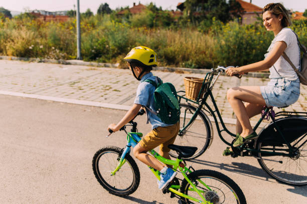 Its a race! Little boy commute to school with mom by bicycles bicycle cycling school child stock pictures, royalty-free photos & images