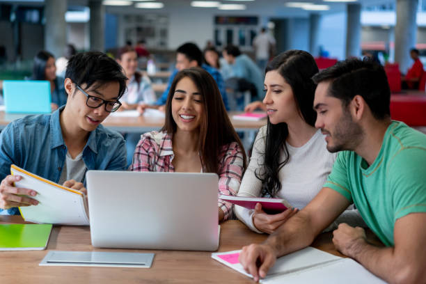 istock Diverse group of students studying together for an exam at the university campus using a laptop and notebooks 1165150770