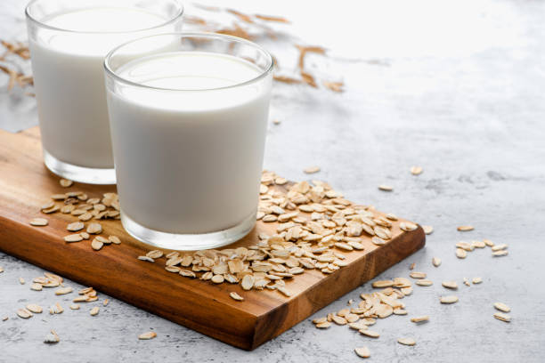 istock Oat milk in a glass cup and oatmeal 1165153244