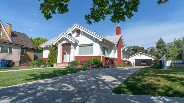 Typical white urban bungalow, Logan, Utah Logan, Utah, United States - August 31, 2018: Typical white urban bungalow shaded by a tree in Logan city center, Utah mormonism photos stock pictures, royalty-free photos & images