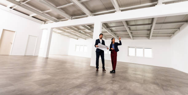 istock Businesspeople Meeting To Look At Plans In Empty Office 1165157454