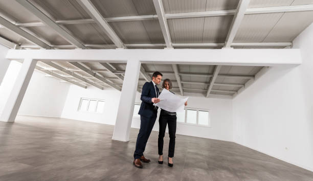 istock Businesspeople Meeting To Look At Plans In Empty Office 1165157465