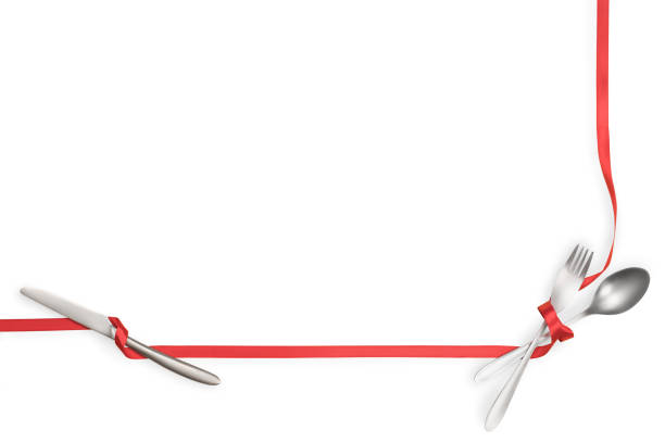 istock Fork, spoon and knife tied with a red ribbon isolated with copy space 1165157763